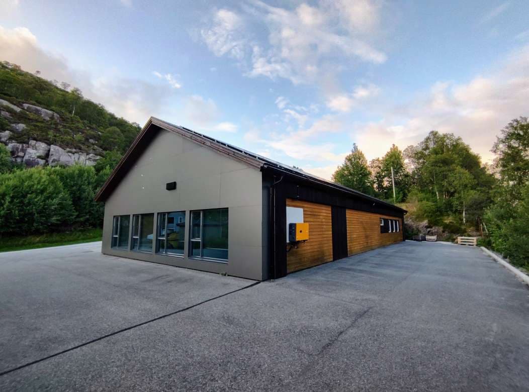 Exterior of the Velox office building in Frakkagjerd, Norway, with large windows and timber cladding